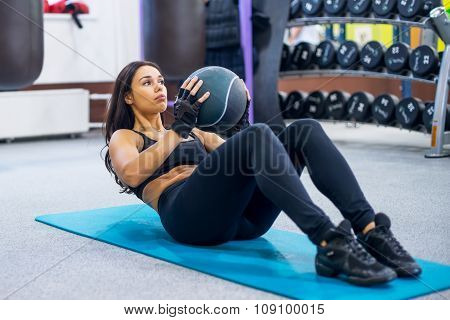 Work out fitness woman doing sit ups abs abdominal crunches core exercises with medecine ball.