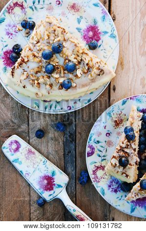 Slice of delicious cake with fresh blueberry on wooden backgroup. Piece of blueberry cake, piece of