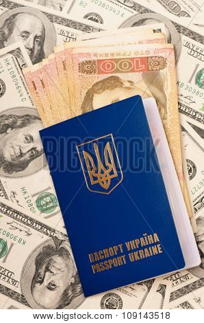 International Ukrainian passport with Hryvna banknotes on US dollars background