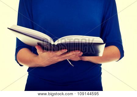 Young caucasian woman reading a book.