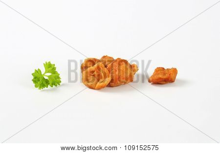 handful of pork greaves on white background