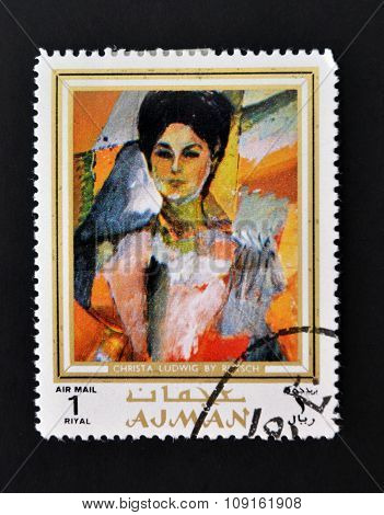 AJMAN - CIRCA 1970 A stamp printed in Ajman shows Christa Ludwig portrait by Alexander Rutsch
