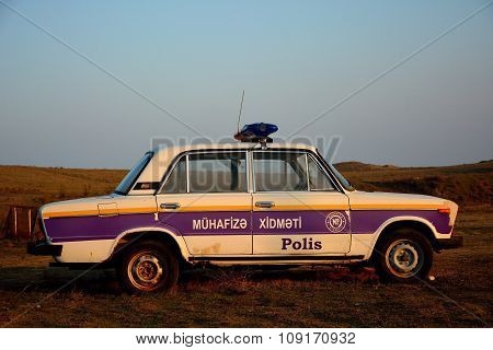 Old Lada police car in Azerbaijan in a rural setting