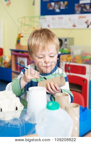 Boy Building Junk Model In Pre School Class