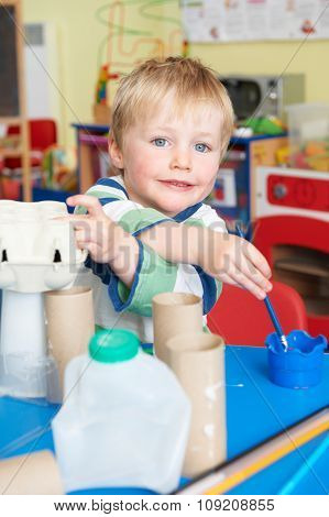 Boy Building Junk Model In Pre School Class