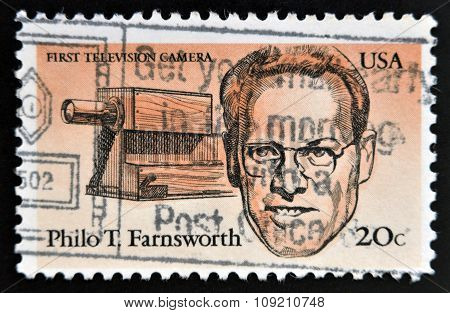 stamp printed in USA shows first television camera and portrait of Philo T. Farnsworth (1906-1971)
