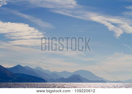 Republic Of Montenegro. Sea, Mountains And Clouds In The Sky. View From The Back Trap Of The Boat.