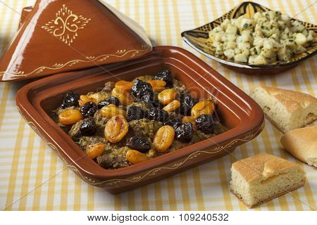 Square tagine with apricots and prunes, potato salad and bread