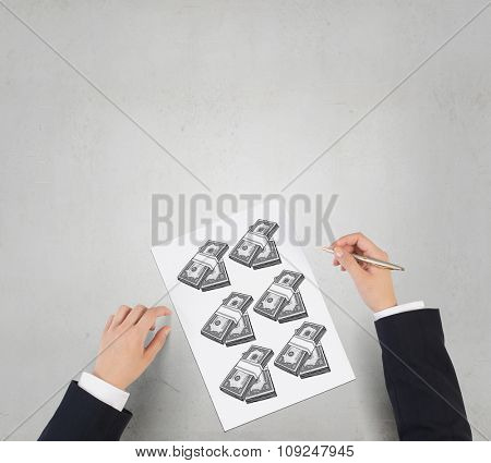 Businessman hands drawing money making formula in notepad