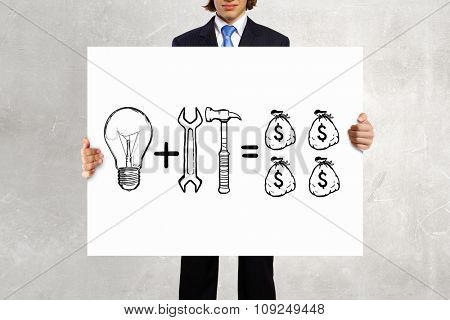 Businessman holding banner with drawn money earning concept