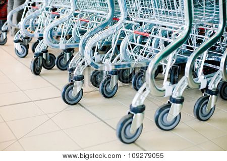 Shopping carts in supermarket ready for consumers. Buy and sell concept