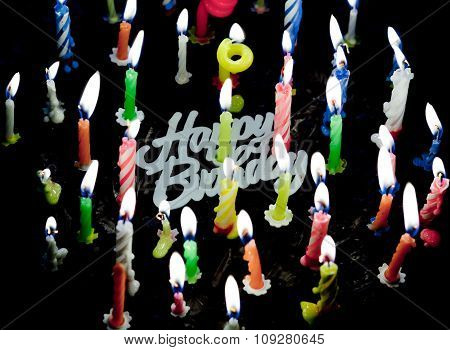 Candels On Chocolate Cake In The Dark