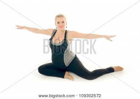 Pregnant woman doing sport exercises in yoga style