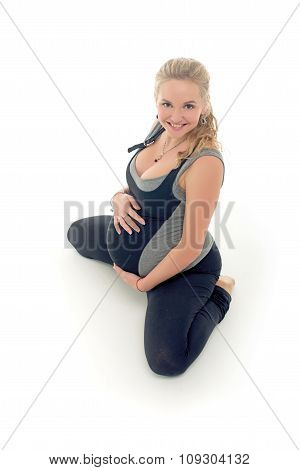 Pregnant woman doing sport exercises in yoga style