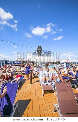 Caribbean Sea, Bahamas - February 13, 2015: Tourists Relax And Take A Sun Bath On The Upper Deck Of