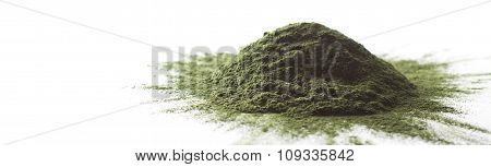 Spirulina raw powder on white background - heap.