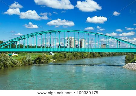 Green Railway bridge over Sava river in Zagreb and modern skyline