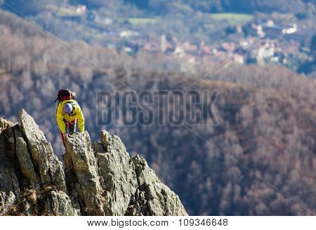 Climber struggle to the summit of a challenging ridge. Sunny autumn day. Italian Alps, Europe.