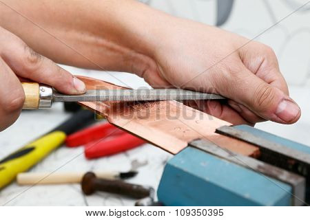 Grinding the copper billet with a file