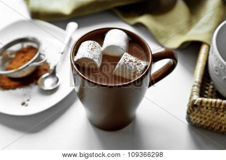 Cup of coffee with marsh mellow on a table