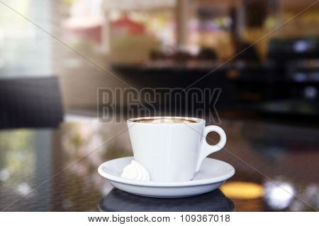 Cup of tasty coffee and zephyr in cafe