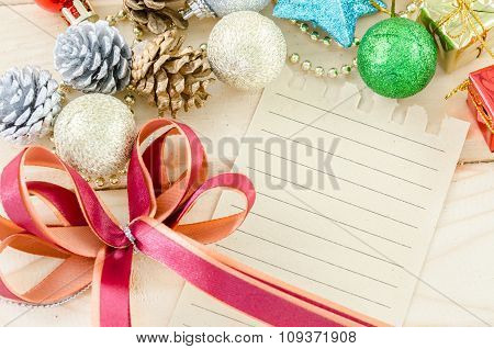 Blan Brown Paper For Your Text With Red Ribbon And Christmas Decorations.