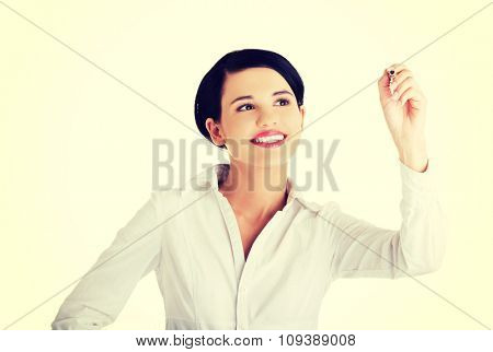 Happy businesswoman drawing on a glassboard