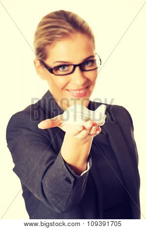 Beautiful businesswoman with plane toy in hand