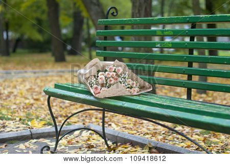 Beautiful bouquet in the paper on the bench