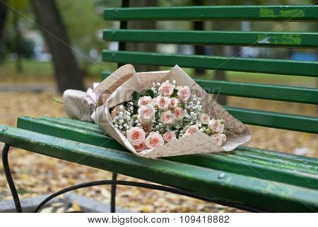 Beautiful bouquet in the paper on the bench