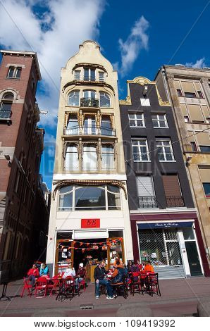 AMSTERDAM NETHERLANDS-APRIL 27: Local outside restaurant on the Rokin street during King's Day on April 27 2015 in Amsterdam the Netherlands.