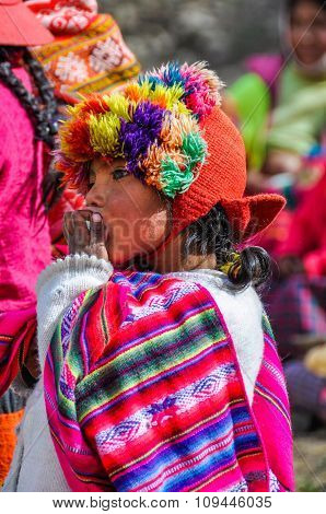 Quechua Girl Eating In A Village In The Andes, Ollantaytambo, Peru