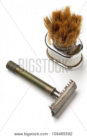 old shaving kit - razor and a shaving brush - on white
