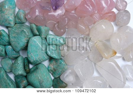 Mineral stones: azonite, pink quartz, rock crystal background