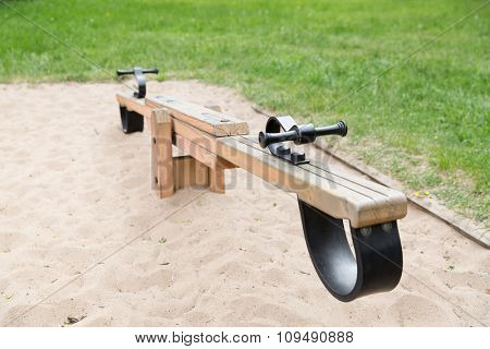 childhood, equipment and object concept - close up of swing or teeterboard on playground outdoors