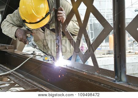 Welders welded the decorative mild steel at the construction site