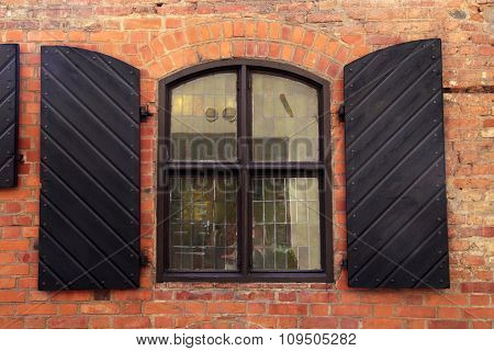 Wall Of Red Brick With Window And Shutters