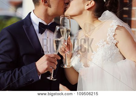 Beautiful Bridal Couple Celebratin With A Glass Of Champagne