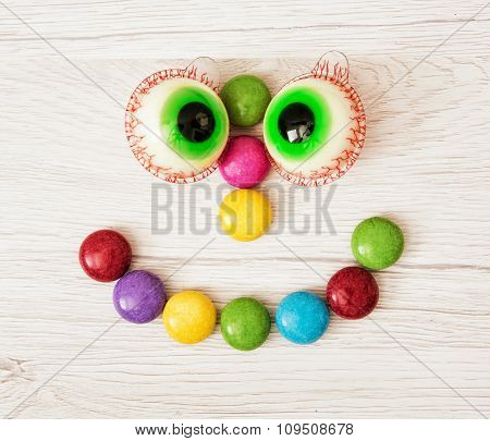 Smiling Face Of Smarties And Chewing Gums In The Form Of Eyes