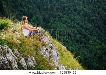 Woman Sitting  At The End Of Earth In Fascinating Landscape