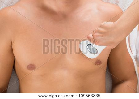 Beautician Giving Laser Epilation On Man's Chest