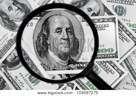 Hundred Dollar Bills And Magnifying Glass