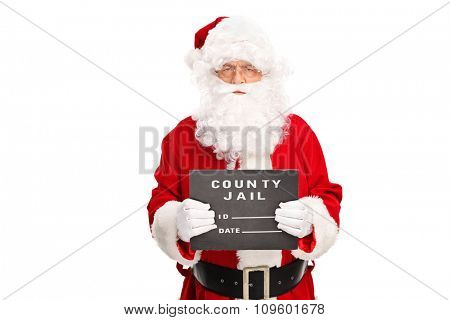 Studio shot of a criminal Santa Claus posing for a mug shot with a black board in his hand isolated on white background