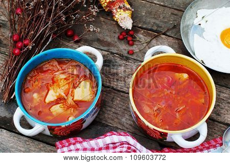 Traditional Ukrainian Russian vegetable borscht on the old wooden background. Ukrainian and russian