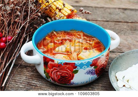 Traditional Ukrainian Russian vegetable borscht on the old wooden background. Ukrainian and russian
