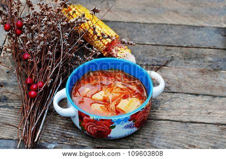 Traditional Ukrainian Russian vegetable borscht on the old wooden background. Ukrainian and russian