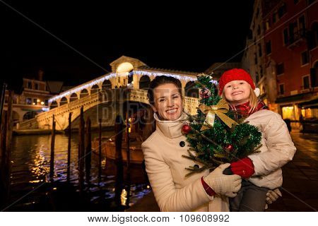 Mother And Daughter With Christmas Tree Near Rialto Bridge