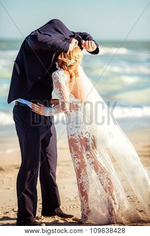 Bride and groom on their wedding day on the beach