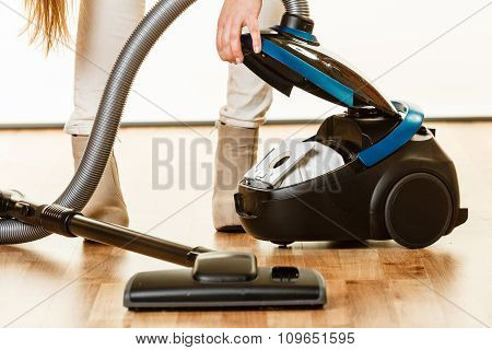 Woman Opening Vacuum Cleaner.