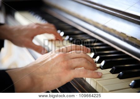 Close up of man hands classic piano playing